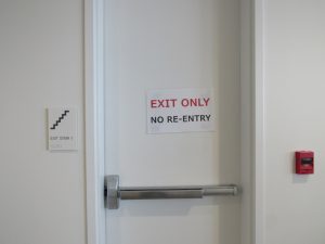 Emergency evacuation door with sign that says "exit only no re-entry"